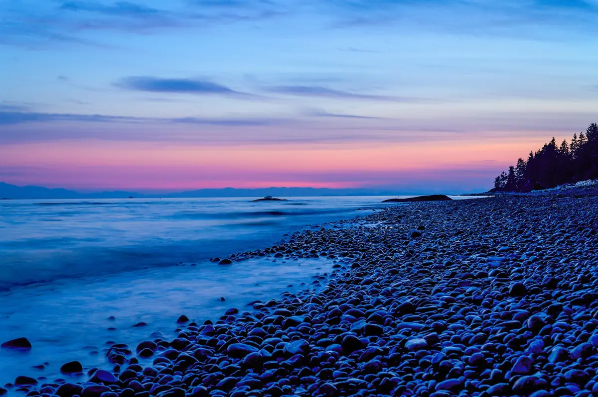 Pebble beach and calm water at blue hour on the Sunshine Coast