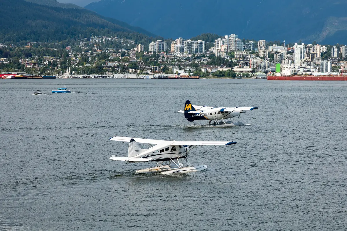 Two seaplanes on the water of Vancouver Harbour with the North Shore behind